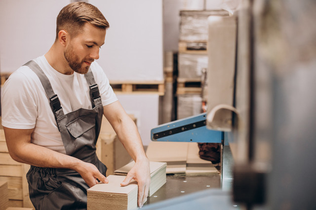 young handsome man working at a factory